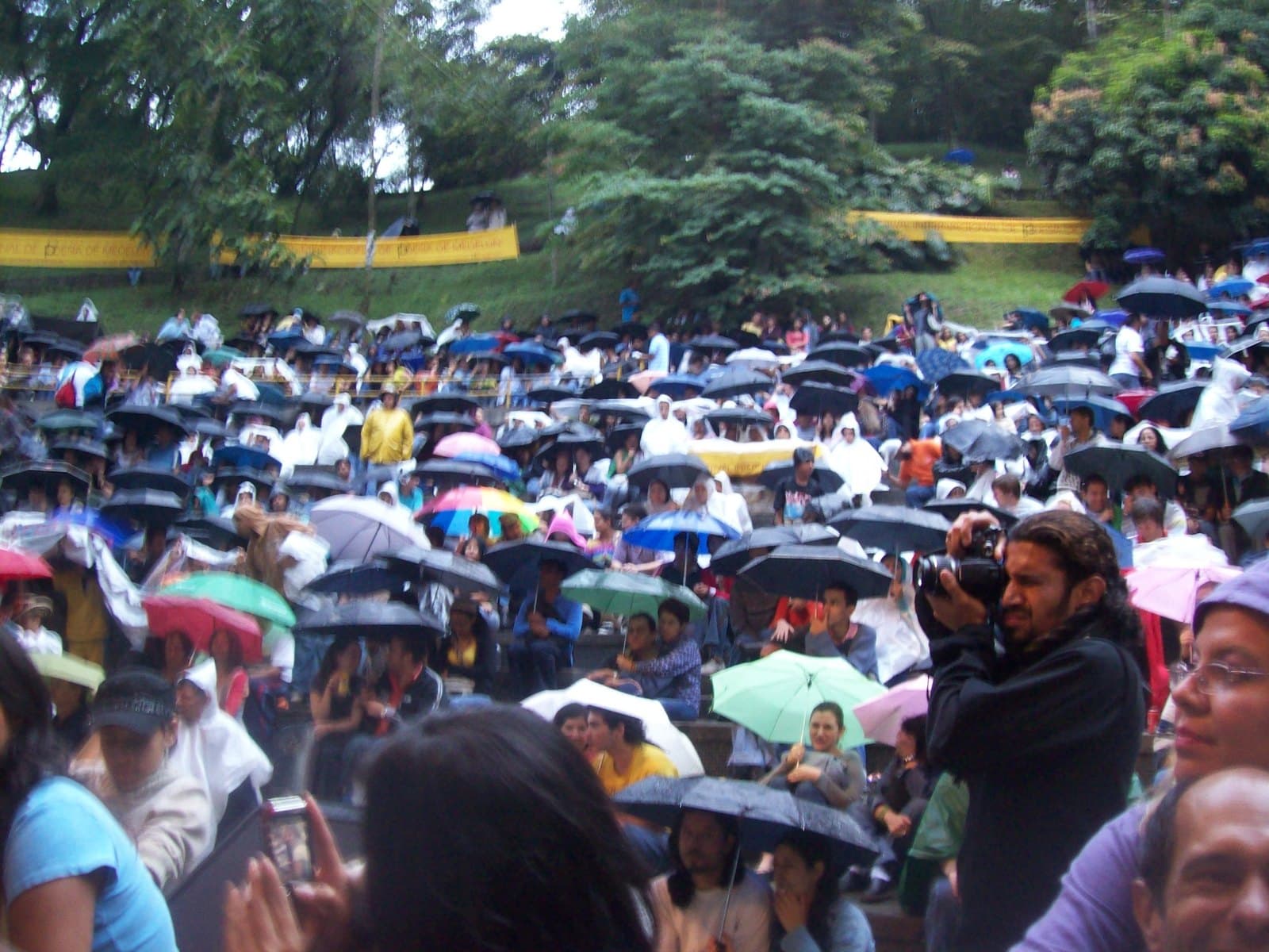 Outdoor audience under a sea of colorful umbrellas at the opening of Medellín’s poetry festival