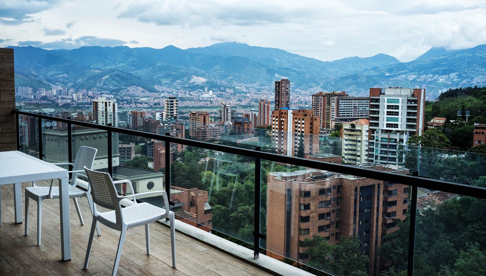 Sunny penthouse terrace overlooking El Poblado's high-rises and the green mountains ringing Medellín