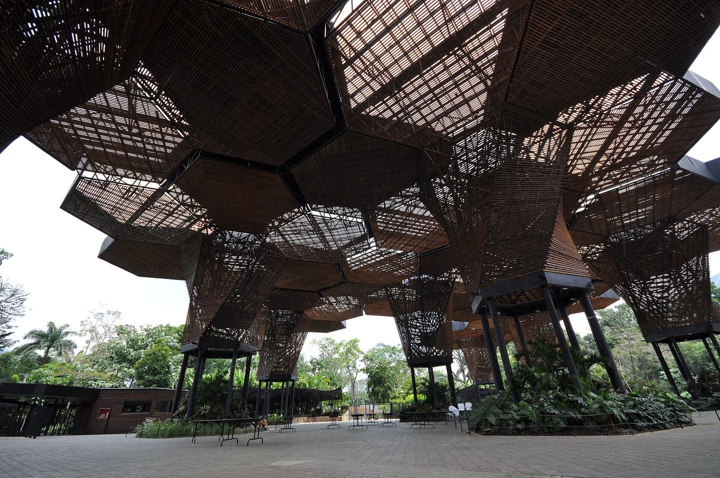 The Orquideorama's giant hexagonal wooden canopy sheltering gardens at Jardín Botánico de Medellín