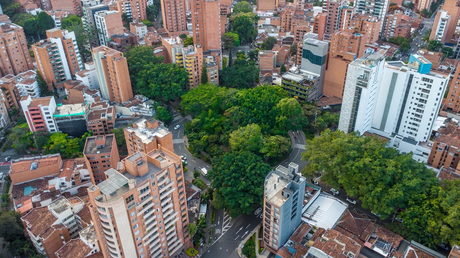 Aerial view of Laureles' leafy streets and terracotta apartment towers in Medellín