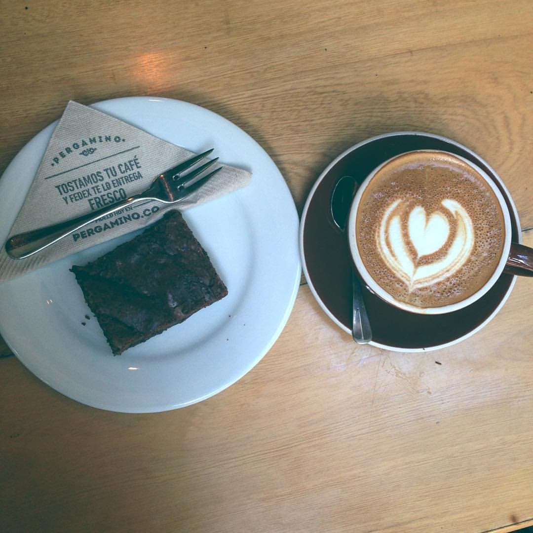 Heart latte art and a brownie on a Pergamino-branded napkin at the Vía Primavera café in Medellín